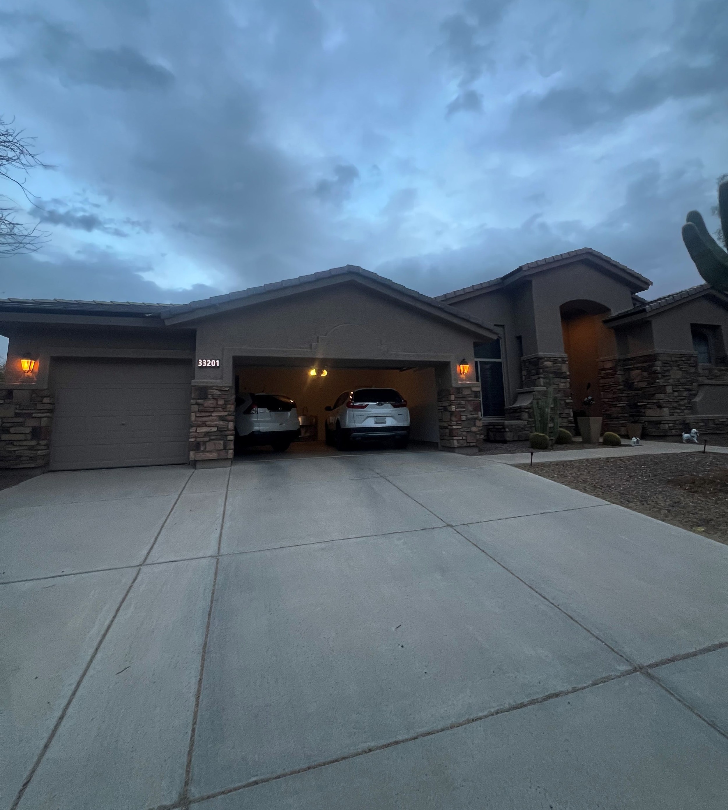 Suburban home at evening with house number barely visible on stone pillar — typical low-visibility installation